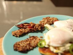 an egg and bacon sandwich on a blue plate