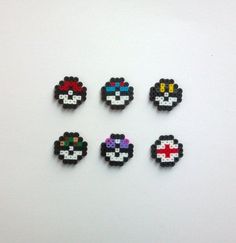 six pacman beads are arranged on a white surface