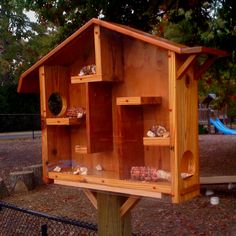 a wooden bird house sitting on top of a tree