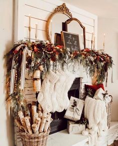 a fireplace decorated for christmas with stockings and wreaths