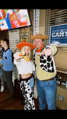 two people dressed up as cowgirls posing for the camera