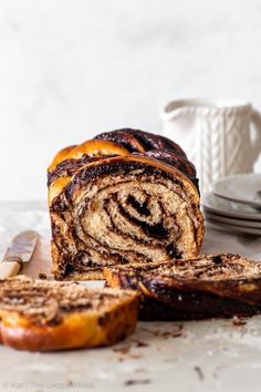 vegan chocolate bake with cinnamon swirl in the center and sliced up on a cutting board