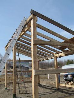 a ladder is attached to the side of a wooden structure that's being built