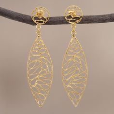 Giuliana Valz-Gen designs a glistening pair of dangle earrings from Peru diligently handcrafting it of gold plated sterling silver filigree. Each earring features a leaf-like shape dangling from the ear on a circular post. Gold Filigree Chandelier Earrings For Anniversary, Gold Sterling Silver Filigree Chandelier Earrings, Gold Filigree Sterling Silver Chandelier Earrings, Gold Linear Pierced Earrings For Gifts, Gold Pierced Linear Earrings For Gift, Filigree Pendant Necklace, Sterling Silver Locket, Ear Ring, Gold Leaf Earrings