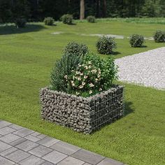 there is a planter made out of rocks in the grass