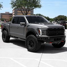 a large gray truck parked in a parking lot