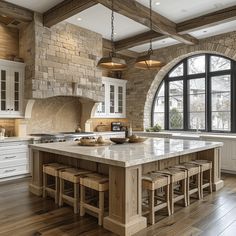 a large kitchen with an island in the middle and lots of counter space on one side