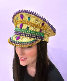 Be the conductor of your Mardi Gras parade in this wild sequin conductor hat! Each one comes in an energetic palette of purple, green, and gold - guaranteed to turn heads and cause a parade of compliments. Get yours today for a look that's not just on-beat, but off-the-charts funky! One Size Fits Most Mardi Gras Adjustable Costume Hat With Round Crown, Adjustable Mardi Gras Costume Hat With Round Crown, Adjustable Costume Accessories For Mardi Gras, Adjustable Round Crown Costume Hat For Mardi Gras, Mardi Gras Festival Costume Hat With Round Crown, Adjustable Costume Hats For Mardi Gras Carnival, Adjustable Costume Accessories For Mardi Gras Carnival, Adjustable Costume Hats And Headpieces For Mardi Gras, High Crown Costume Hats For Mardi Gras Party