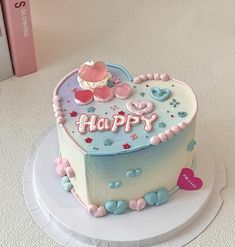 a heart shaped birthday cake on a plate