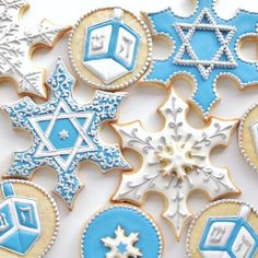 decorated cookies with blue and white icing are arranged in the shape of snowflakes