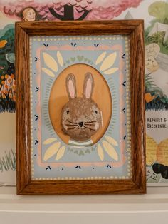 a wooden frame with an image of a rabbit in the center