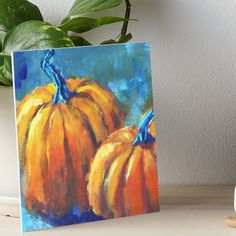 two orange pumpkins on a blue background art board