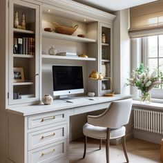 a white desk with a computer on top of it