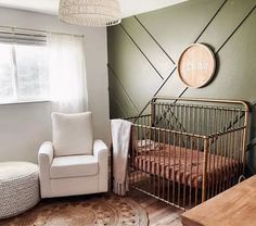 a baby's room with a crib, rocking chair and large round rug