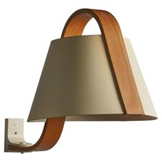 a wooden and metal wall light with a white shade on the bottom half of it