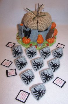 there are knitted pumpkins and other items on the table with tags around them