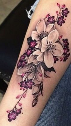 a woman's arm with flowers on it