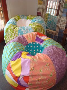 the bean bag chair is colorfully decorated and ready to be used as a child's bed