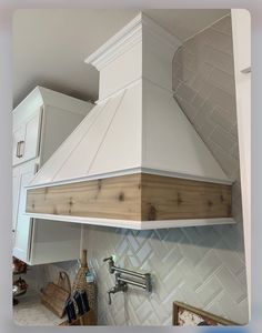 a stove top oven sitting inside of a kitchen next to a wall mounted faucet