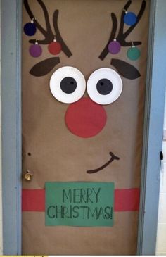 a door decorated to look like a reindeer with christmas decorations on its nose and nose