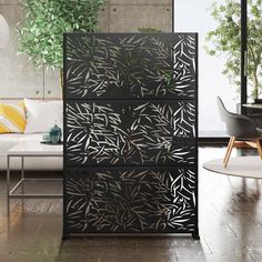 a living room with a white couch and a black cabinet