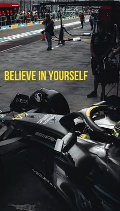 a black race car with the words believe in yourself written on it