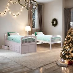 a bedroom with two twin beds and a christmas tree