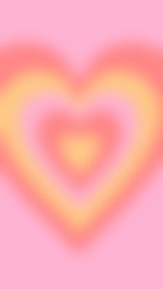 a pink and yellow heart shaped object on top of a pink background with an orange center