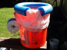 an inflatable bucket sitting on top of a wooden bench