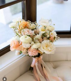 a bouquet of flowers sitting on top of a window sill