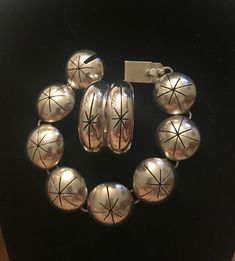 Taxco Mid century Modern Bracelet & earrings set.  Demi parure set.  Starburst design.  1950s 1960s. Space age.  Quintessentially MCM Mexico.  Bracelet: Measures 7 1/2" (7 1/4" wrist) Half dome hollow panels.  7/8" diameter.  Working secure clasp.  Slide in clasp.  Marked: TV-140 Mexico 925.  Hoop Earrings: Measure:  1 3/8" diameter.  1/2" width.  Pierced. French wire.  Marked: TM-159 Mexico 925.  Large but not weighty.  Statement pieces.  Previously owned.  Excellent vintage condition.  I polis Mid-century Polished Formal Jewelry, Vintage Sterling Silver Clasp Jewelry For Anniversary, Mid-century Bracelet Jewelry Gift, Mid-century Polished Finish Jewelry For Anniversary, Mid-century Handmade Formal Jewelry, Mid-century Round Jewelry Gift, Nickel-free Retro Jewelry For Anniversary, Retro Silver Bracelet Jewelry, Retro Nickel Free Jewelry For Anniversary