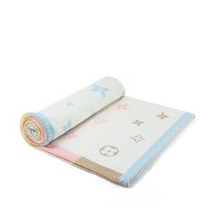 a rolled up baby blanket on top of a white surface with pink and blue stars