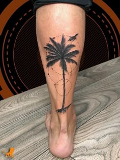 a person with a palm tree tattoo on their leg