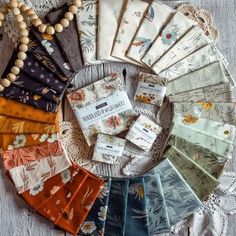 several pieces of fabric laid out on top of a wooden table next to each other