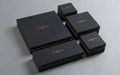 four black boxes sitting on top of each other with writing on the inside of them