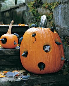 two pumpkins with holes in them sitting on steps