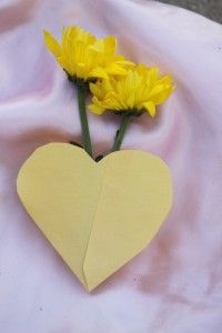 two yellow flowers are placed in the shape of a heart