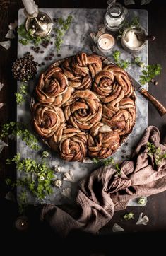 a table topped with a pie covered in icing