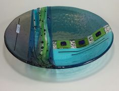 a blue plate with green and white designs on it