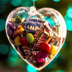 a heart shaped ornament filled with candy