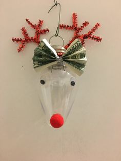 a glass ornament with money in the shape of a reindeer's head