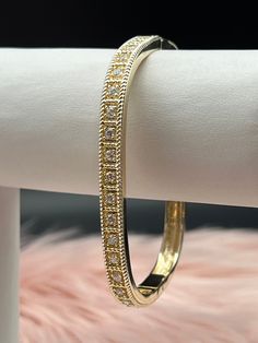 The CZ Diamond Square Bangle Bracelet is a contemporary and elegant accessory, featuring a sleek square-shaped design encrusted with dazzling cubic zirconia (CZ) diamonds. This sophisticated bracelet offers a modern twist on the classic bangle, making it a perfect blend of luxury and style. Size: 7 1/4 inches - Inner Diameter Material: Brass with 18K Gold Plating with Rhodium Coating Lead Free and Hypoallergenic Dazzling Cubic Zirconia Bracelets With Elegant Design, Dazzling Cubic Zirconia Bracelet With Elegant Design, Elegant Bangle Cuff Bracelet With Sparkling Stones, Elegant Cuff Bracelet With Sparkling Stones, Elegant Cubic Zirconia Crystal Bangle Bracelet, Elegant Rectangular Diamond Cut Bracelet, Rectangular Cubic Zirconia Bracelets, Luxury Bangle Diamond Bracelet With Sparkling Stones, Luxury Diamond Bangle Bracelet With Sparkling Stones