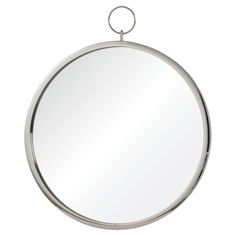 a round mirror hanging on the wall with a metal ring around it's edge