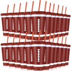 football paper cups with orange straws in them are lined up and ready to be eaten