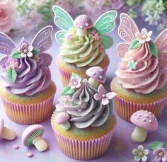 three cupcakes decorated with fairy wings and flowers