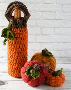 three crocheted pumpkins sitting next to each other