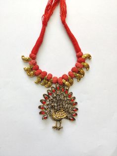 Here's an Indian Vintage Oxidized Necklace you can show off your style with! It's bold, it's beautiful and it's sassy! Grab on this Gold Peacock Oxidized Necklace embedded with red stones and thread chain. Specifications: Vintage Necklace Bird Pendant - Peacock Gold Oxidized Plating Mixed Metals Red Glass Stone Bold Statement Jewelry Red Peacock Design Temple Jewelry Necklace, Red Temple Jewelry Necklace With Peacock Design, Red Adjustable Temple Jewelry Necklace, Red Peacock Design Necklace As A Gift, Red Peacock Design Necklace As Gift, Red Peacock Design Necklace For Gift, Festive Red Jewelry With Peacock Design, Festive Red Peacock Design Necklace, Red Temple Jewelry With Peacock Design