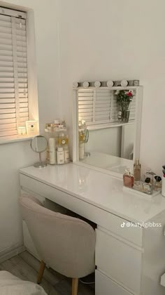 a white vanity and chair in a small room