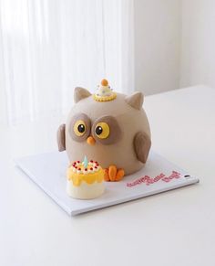 an owl cake with a candle on top