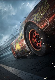 a close up of a car with flames coming out of it's tires on a race track